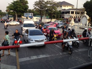 Traffic waiting at the crossing while the train passes.