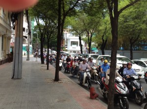 Motorbikes take up every spare inch of the road.