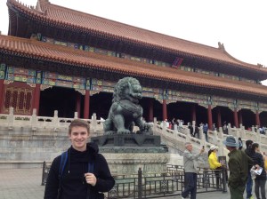 Standing with a lion statue inside the Forbidden City.