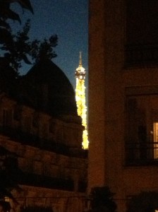 The Eiffel Tower sparkling in the distance.