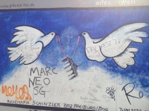 Doves carrying the Brandenburg Gate, an iconic symbol of Berlin.