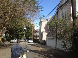 Vincenzo walking the broken down moped through the streets of the Garden District. 